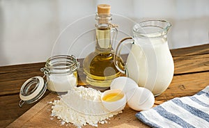 Pancakes ingredients. Milk egg flour oil sugar. Wooden background