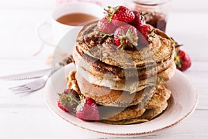 Pancakes over white wooden background