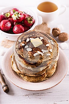 Pancakes over white wooden background