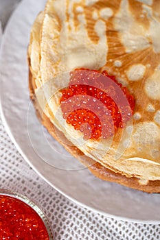 Pancakes on a plate with red caviar