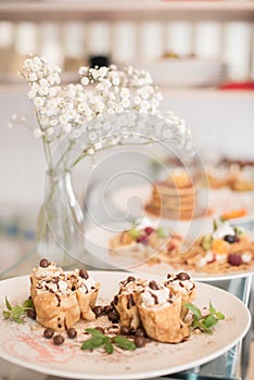 decorated pancakes and flowers in vase photo