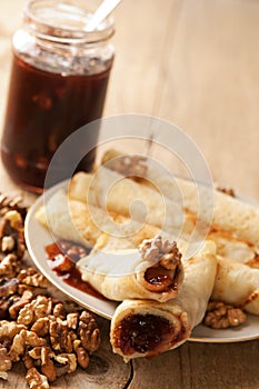 Pancakes with plums jam and walnuts filling