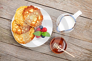 Pancakes with raspberry, blueberry, milk and honey syrup