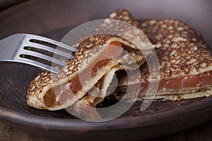 Pancakes of rye flour with salted salmon.