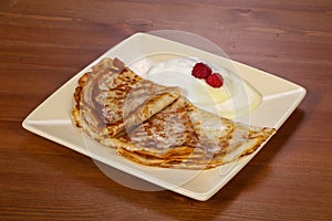 Pancakes with sour cream and condenced milk photo