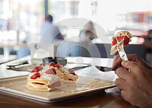 Pancakes with stawberries and cream ,the best breakfast for children and adults . Man eats dessert. Healthy eating for lunch . Clo