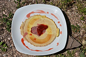 Pancakes with fresh strawberries on white plate