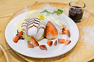 Pancakes with Strawberry and Vanilla Ice cream with chocolate to