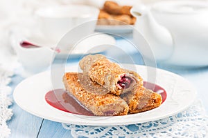 Pancakes stuffed with cherries and cherry sauce