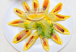 Pancakes stuffed with red fish and cut into pieces. Plate with pancakes close-up