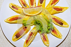 Pancakes stuffed with red fish and cut into pieces. Plate with pancakes close-up