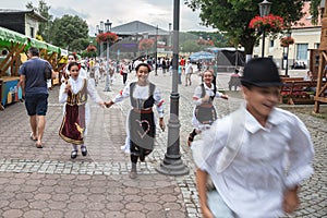 Serbian children wearing traditional folkloric costumes of Serbia with typical dresses for girls and peasant clothing forboys