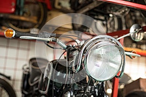 Pancevo, Serbia - September 27, 2019: Front light of Old timer motorcycle parked in collectors museum