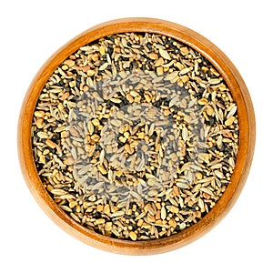 Panch phoron, whole spice blend in wooden bowl over white