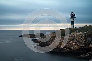 Pancha island lighthouse at sunset in Ribadeo coast, Lugo province, Galicia, Spain