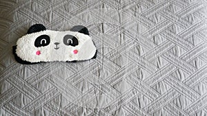 Panda sleep mask on a pillow ready for a sleep night  and soft cute dreams
