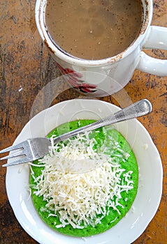 Pandan  pancake topped with shredded chedar cheese with a cup of coffee