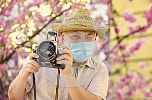 Pandemic concept. Risky photographer. Keep working. Pollen allergy. Tourist camera photo. Nature photography. Senior man