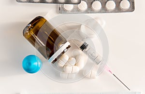 Pandemic of coronavirus COVID-19. spray, pills, drops and syringe on white background. medicina, quarantine. photo