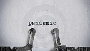 pandemic text typed on blank sheet with an old typewriter in vintage background