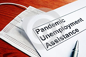 Pandemic Unemployment Assistance PUA and medical mask photo