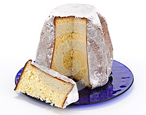 Pandoro with slice on blue plate photo