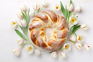 Pane di Pasqua, traditional Easter bread surrounded by tulip flowers photo