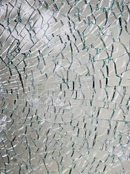 A pane of safety tempered glass shattered in many pieces.