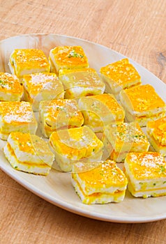 Paneer Burfi or Paneer Kesar Burfi is a Traditional Indian Sweet Food on Wooden Background