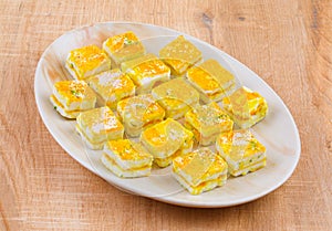 Paneer Burfi or Paneer Kesar Burfi is a Traditional Indian Sweet Food on Wooden Background