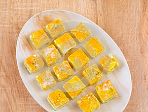 Paneer Burfi or Paneer Kesar Burfi is a Traditional Indian Sweet Food on Wooden Background