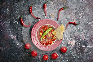 Paneer Makhani in pink plate on dark background