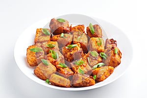 Paneer Manchurian or Paneer 65 in white plate at white background
