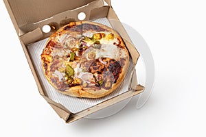 Paneer pizza in open delivery box in cardboard box on white background. Top view. Space for text. Pizza delivery