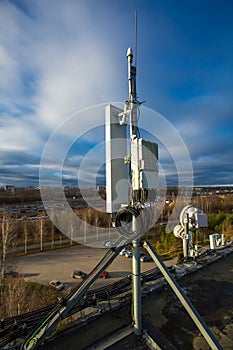 Panel antenna of GSM DCS UMTS LTE bands and radio unit are as part of communication equipment of basic station are installed on photo