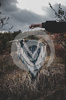 Panel of blue and white macrame on a decorative branch