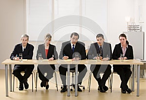 Panel of co-workers about to conduct an interview photo