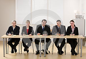 Panel of co-workers about to conduct an interview photo