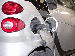 Panel with two guns for charging electric vehicles