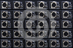 A panel of XLR outlet connectors. The XLR connector is a style of electrical connector, primarily found on professional audio