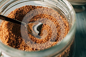 Panela brown sugar as background. Close up view of raw cane sugar in a jar. photo