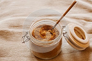 Panela sugar background. Close up view of raw cane sugar in a jar. photo