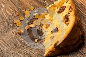 Panettone bread and ingredients on rustic wood ambient.