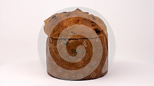 Panettone. Close up of traditional Italian sweet yeast bread loaf rotating in turn table isolated on white background.