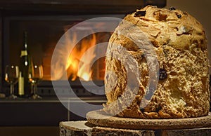 Panettone, fireplace and wine in background