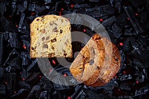 Panettone placed on black charcoal with red fire background