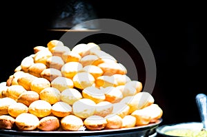 Pani Puri stall with lots of gol gappe placed in pile