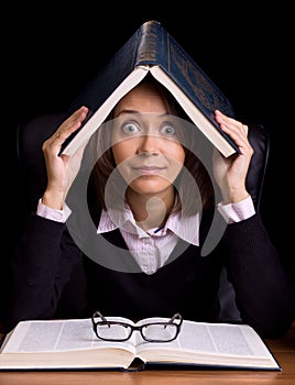 Panic woman with book at the table