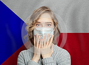 Panicked shocked woman in medical face mask on Czech Republic flag background. Flu epidemic and virus protection concept