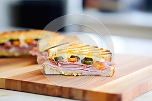 panini grill marks on a sandwich filled with ham and cheese